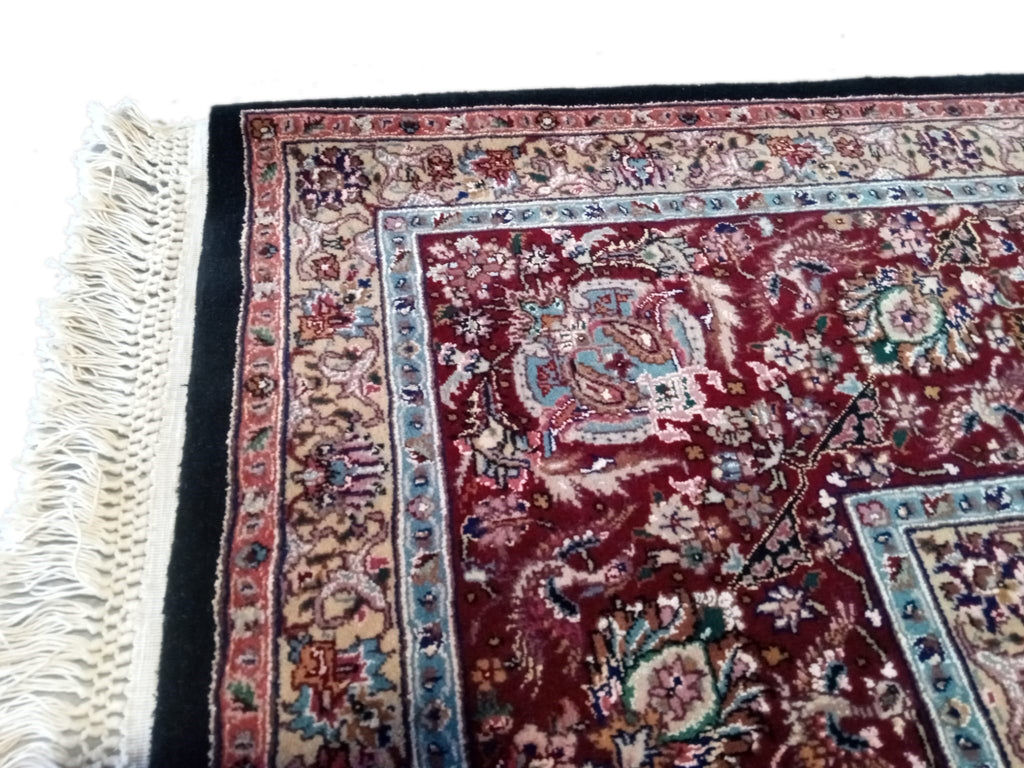 Handcrafted 8x12 Indian Tabriz rug with intricate designs and vibrant colors, showcasing traditional craftsmanship and luxurious texture, perfect for elegant home decor.