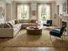 Load image into Gallery viewer, Living room with beige sectional sofa, round wooden coffee table, and blue chairs.