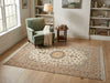 Load image into Gallery viewer, Living room with a green armchair, patterned rug, and bookshelves.
