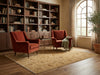 Load image into Gallery viewer, A styled interior scene with two rust-red armchairs arranged on a large beige patterned area rug in a sunlit room with wood floors, a bookshelf, and a window.