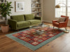 Load image into Gallery viewer, A styled living room scene featuring a large area rug with a teal border and a red, blue, and beige patchwork pattern, placed under a glass-top coffee table between a green sofa and an orange armchair.