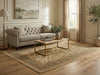 Load image into Gallery viewer, A styled living room scene featuring a light beige tufted sofa, a rectangular coffee table with a gold metal frame, a large traditional patterned area rug, a floor lamp, and a potted tree in a bright room with wood floors and beige walls.
