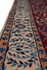 Load image into Gallery viewer, A close-up of a patterned area rug showing detailed woven motifs in beige, red, blue, green, and black.
