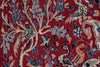 Load image into Gallery viewer, A close-up of a traditional patterned rug featuring a deep red background with beige branches, blue floral clusters, and stylized birds in muted green, blue, and beige tones.