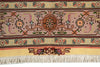 Load image into Gallery viewer, A close-up of a patterned rug showing a central medallion, floral motifs, and cream fringe along the bottom edge.