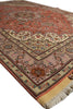Load image into Gallery viewer, A traditional Persian-style area rug with a warm rust red field, beige border, and intricate floral motifs in blue, green, and pink, shown on a white background.