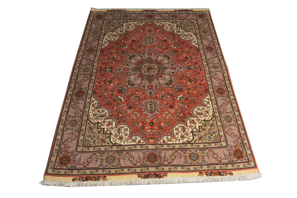 A traditional oriental area rug with a red central medallion, beige and brown borders, and white fringe, shown flat against a white background.