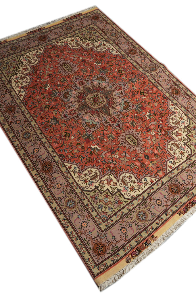 A traditional Persian-style area rug with a red central field, beige and brown borders, and cream fringe, shown on a plain white background.