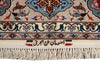 Load image into Gallery viewer, Close-up of an ornate patterned rug corner with cream fringe, featuring a beige field, blue and red floral motifs, and black Arabic calligraphy on a white background.