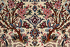 Load image into Gallery viewer, Close-up of an ornate patterned rug featuring a cream background with detailed floral motifs, birds, and tree branches in red, blue, green, and brown.