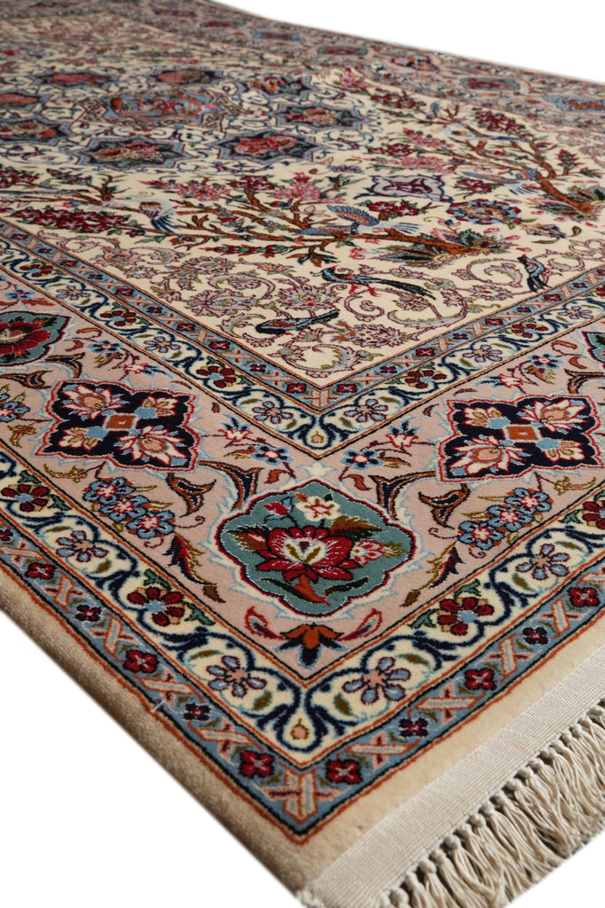 A close-up of a traditional oriental rug with a beige background and intricate floral motifs in red, blue, green, and brown, featuring a fringed edge.