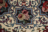 Load image into Gallery viewer, Close-up of a traditional patterned rug featuring a central floral medallion with red and pink roses, green leaves, and blue accents on an off-white background.