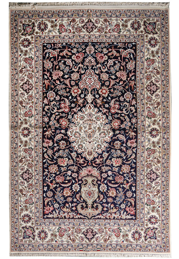 A traditional oriental rug with a dark navy blue central field, surrounded by an ornate cream and beige border with pink, red, and green floral motifs.
