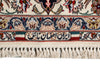 Load image into Gallery viewer, Close-up of an ornate patterned rug with cream, navy, red, and beige floral motifs, decorative bands, and a fringed edge.