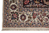 Load image into Gallery viewer, Close-up of an ornate patterned rug corner showing cream ground with navy, red, beige, and gold floral and bird motifs, plus a fringed edge.