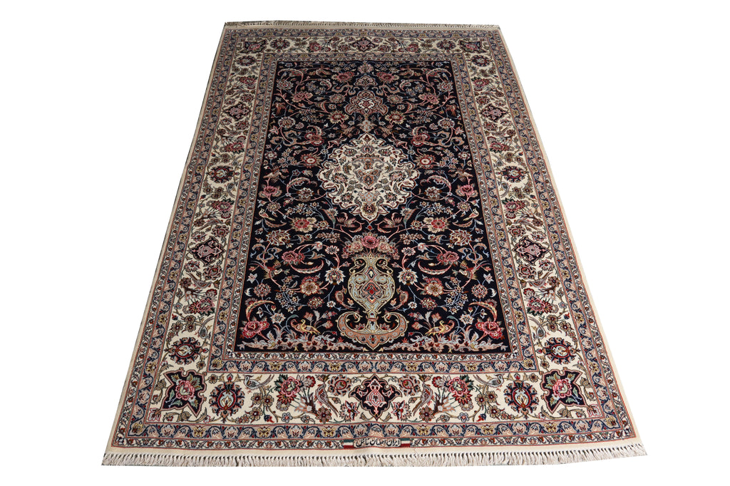 A traditional oriental area rug with an intricate floral pattern, featuring a dark navy blue center field, cream borders, and multicolored floral motifs, shown flat against a white background.