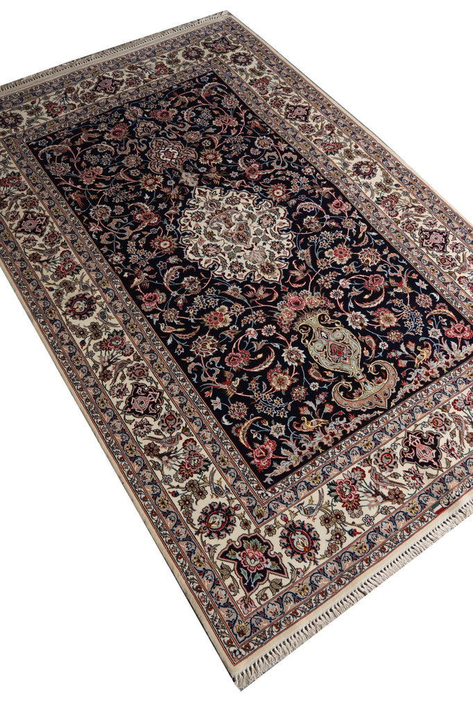 A traditional Persian-style area rug with an intricate floral pattern, featuring a dark navy blue center, beige borders, and red and green accents, shown on a plain white background.