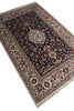 Load image into Gallery viewer, A traditional Persian-style area rug with an intricate floral pattern, featuring a dark navy blue center, beige borders, and red and green accents, shown on a plain white background.