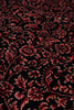 Load image into Gallery viewer, A close-up of a dark red and black floral patterned rug or textile with an ornate damask-style floral design.