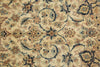 Load image into Gallery viewer, A close-up of an ornate floral patterned rug with a cream background and intricate designs in navy blue, beige, and light blue.
