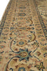 Load image into Gallery viewer, A close-up view of an ornate area rug with a traditional floral and vine pattern in beige, blue, brown, and muted green tones.