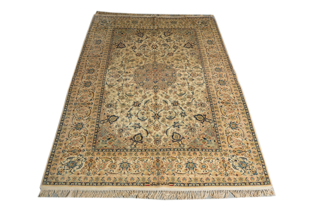 A rectangular traditional area rug with an intricate floral and medallion pattern, featuring a beige and cream base with blue, green, and brown accents, finished with a fringed edge.