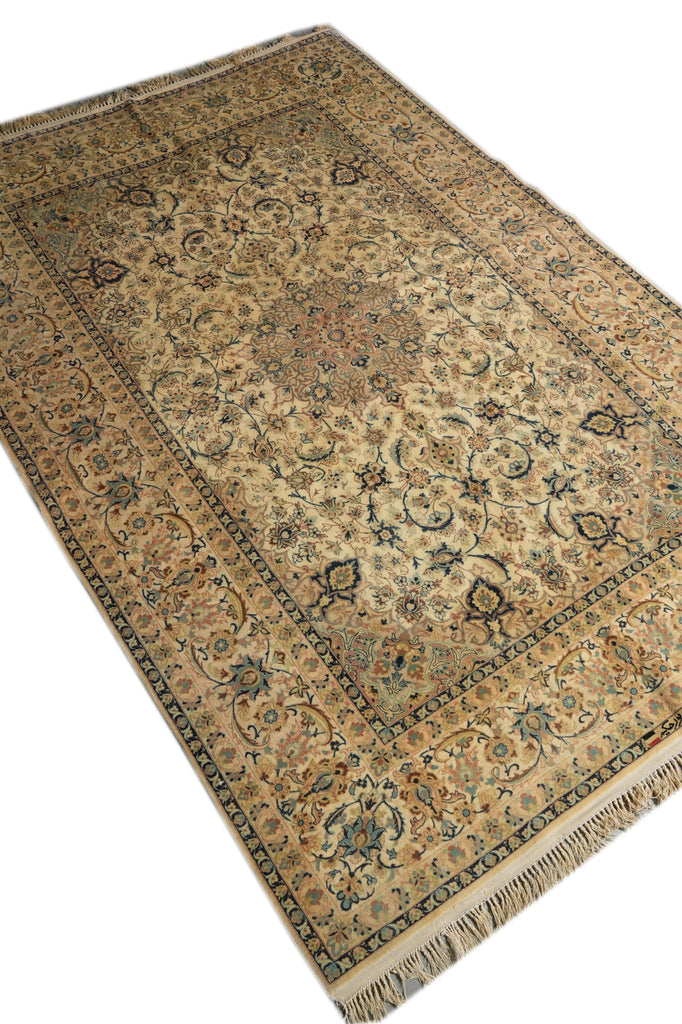 A traditional Persian-style area rug with an intricate floral and vine pattern, shown from an angled overhead perspective on a white background.