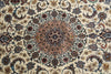 Load image into Gallery viewer, A close-up of an ornate Persian-style area rug featuring a central medallion and intricate floral motifs in beige, brown, blue, and muted red tones.