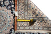 Load image into Gallery viewer, A close-up of a patterned area rug with one corner folded back to show the underside and fringe, alongside a yellow tape measure and a small handwritten size tag on a white background.