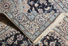 Load image into Gallery viewer, A close-up of a traditional patterned rug with cream, beige, light blue, and black floral motifs, showing the corner and fringe detail.