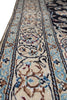 Load image into Gallery viewer, A close-up view of an ornate patterned area rug with a cream base, featuring blue, brown, and black floral motifs and borders.