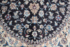 Load image into Gallery viewer, A close-up of an ornate traditional rug featuring a dark navy blue field with a cream border and intricate floral motifs in blue, beige, and red.
