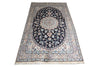 Load image into Gallery viewer, A traditional oriental area rug with a central medallion, featuring a dark navy blue field, beige and cream borders, and light blue floral details, shown flat against a white background.