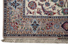Load image into Gallery viewer, Close-up of an ornate traditional rug corner showing a cream field, floral motifs in blue, red, and green, a beige border, and fringe along the bottom edge.