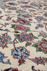 Load image into Gallery viewer, Close-up of a traditional floral patterned rug with cream background and multicolored blossoms in blue, pink, green, and brown.