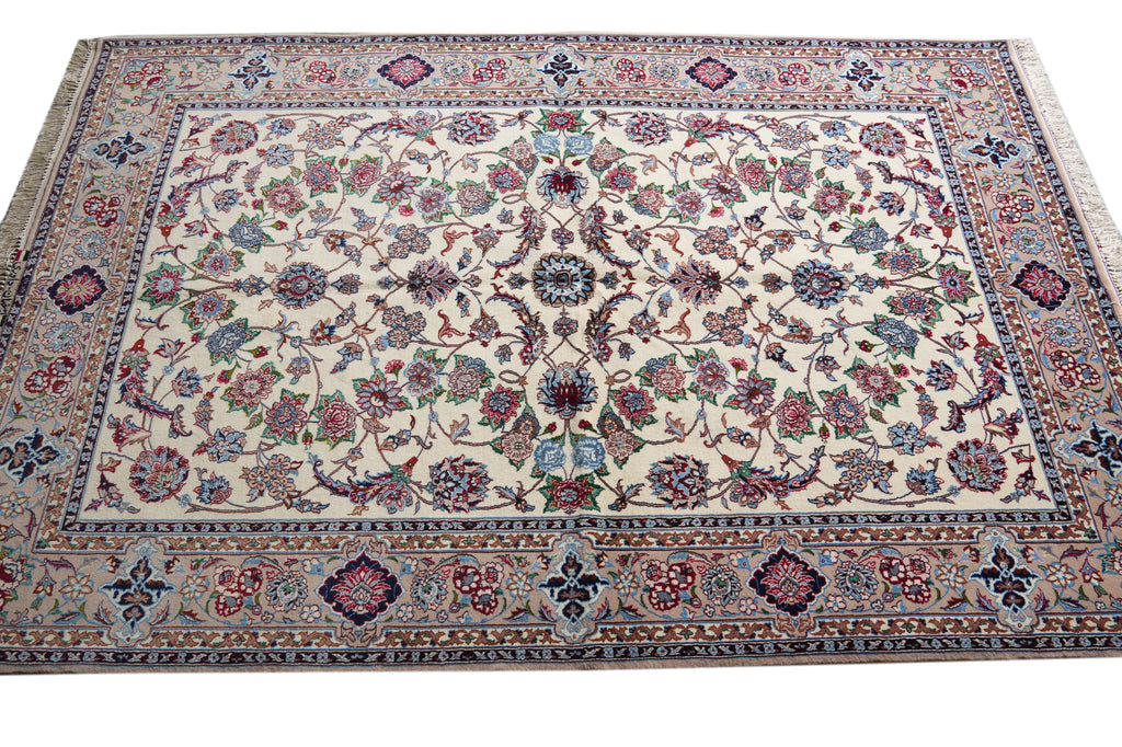 A traditional Persian-style area rug with an intricate floral and vine pattern, featuring a cream center field, detailed multicolor borders, and small fringe on the top and bottom edges.
