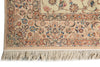 Load image into Gallery viewer, Close-up of a traditional patterned rug corner showing floral motifs, ornate borders, and cream fringe on a white background.