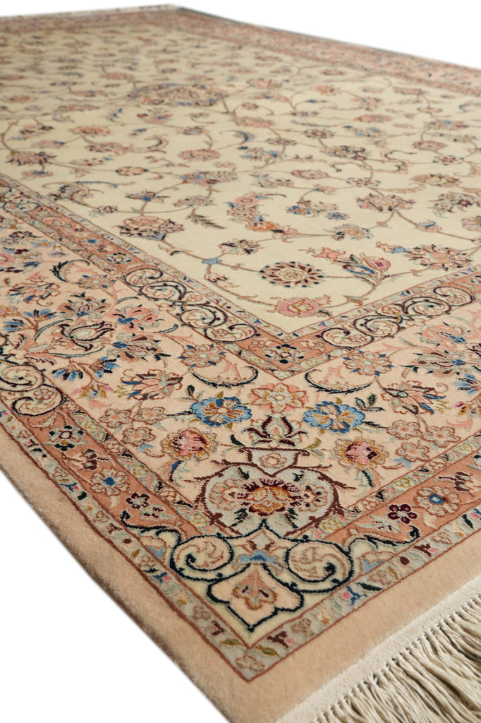 A traditional oriental-style area rug with an intricate floral and scroll pattern, featuring a cream center field, a peach and beige border, and cream fringe on the edge.