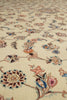 Load image into Gallery viewer, Close-up of a traditional patterned rug with a cream background and delicate floral motifs in pink, blue, and brown.
