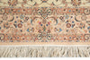 Load image into Gallery viewer, A close-up of an ornate patterned rug showing a cream and beige base with intricate floral motifs in blue, pink, and brown, finished with a thick cream fringe along the bottom edge.
