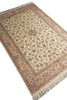 Load image into Gallery viewer, A traditional oriental-style area rug with an intricate floral pattern, featuring a beige center, a dusty pink border, and cream fringe on the ends.
