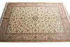 Load image into Gallery viewer, A rectangular traditional area rug with an intricate floral and vine pattern, featuring a cream center field, a dusty pink border, and blue and green accents, shown flat against a white background.