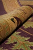 Load image into Gallery viewer, Close-up of a rolled section of a patterned rug showing its texture and color details, featuring a mix of purple, gold, green, and brown tones.