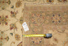 Load image into Gallery viewer, A close-up of a patterned area rug with a tape measure and price tag laid across it to show scale and condition.