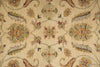 Load image into Gallery viewer, A close-up of a traditional patterned rug with a beige background and ornate floral motifs in muted green, yellow, and burgundy.
