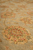 Load image into Gallery viewer, Close-up of a traditional patterned area rug with a beige base and floral motifs in muted red, green, and tan.