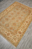 Load image into Gallery viewer, A rectangular area rug with an intricate floral pattern, displayed on a gray wood-look floor. The rug features a beige center field with a warm tan border and motifs in muted orange, green, and brown.