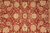 Load image into Gallery viewer, A close-up of a red and beige floral patterned rug or textile, showing an ornate repeating botanical design with cream-colored motifs on a rust-red background.