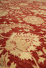 Load image into Gallery viewer, A close-up of a patterned area rug with a traditional floral design in red and beige.