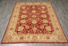 Load image into Gallery viewer, A rectangular traditional area rug with a red field and beige floral motifs, laid flat on a gray wood-look floor.
